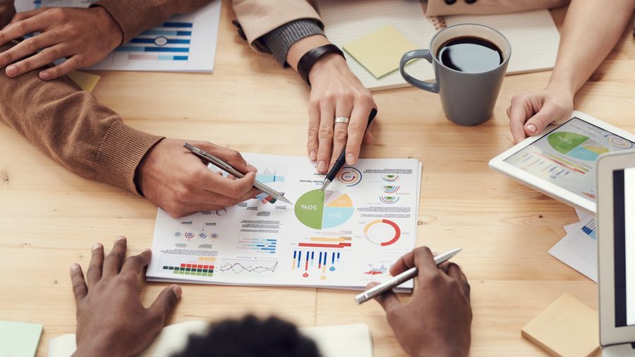 A business team reviewing growth charts and financial data together